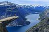 Trolltunga. Fjeldvandrer p� Trolltunga, en klippeformation der stikker ud af klippesiden 700 meter over Ringedalvatnet n�r Hardangervidda National Park  Trolltunga / Tyssedal Norge   Vandring, vandretur, fjeldvandring, turisme, hiking